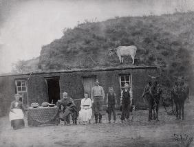 American pioneer family in front of their home (b/w photo) 