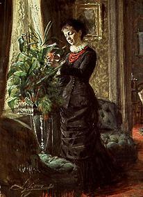 Mrs Lisen Samson when arranging flowers in front of a window od Anders Leonard Zorn