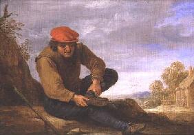 Seated man removing his shoe (panel)