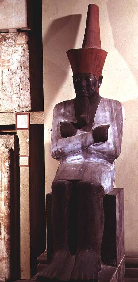 Statue of Mentuhotep II, enthroned and wearing the red crown of Lower Egypt, taken from the Mortuary od Egyptian