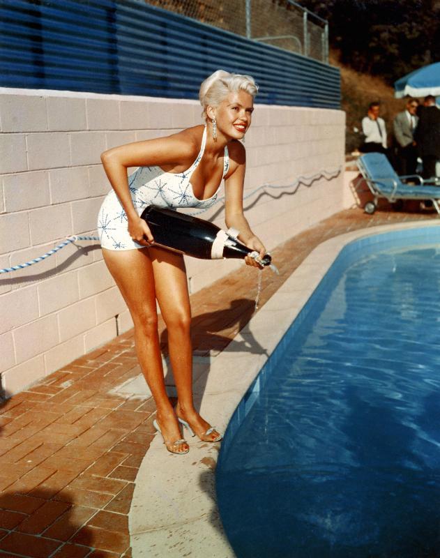 American Actress Jayne Mansfield with a bottle of champagne, near a swimming pool od English Photographer, (20th century)