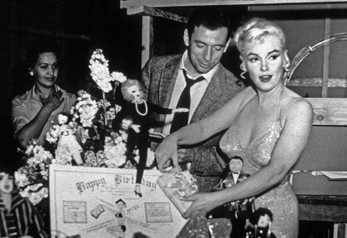 French Actor Yves Montand, American Actress Marilyn Monroe and a birthday cake. od English Photographer, (20th century)