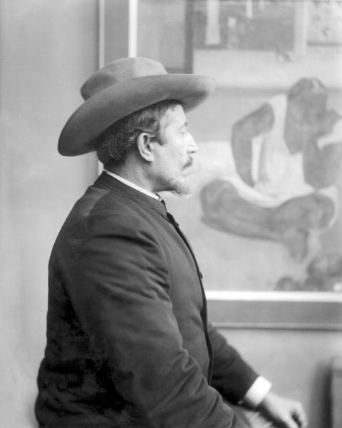 Paul Gauguin (1848-1903) in front of his canvases (b/w photo)  od French School