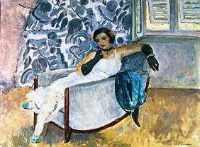 Lady with black gloves, sitting in an armchair.