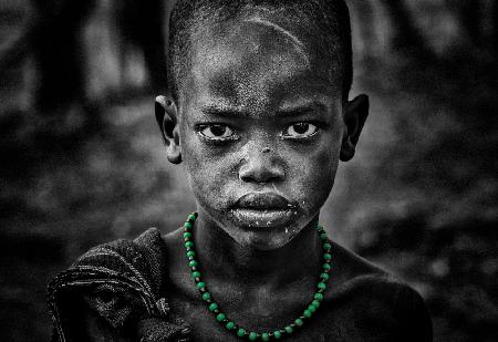 Surmi boy with a green necklace