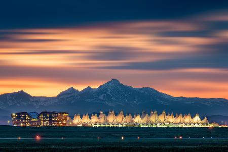 Denver International Airport in dusk with Longs Peak as background