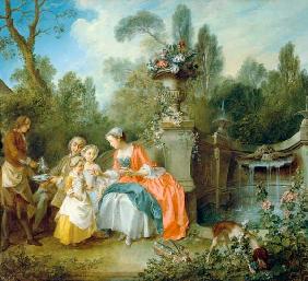 A lady in the garden who drinks coffee with some children