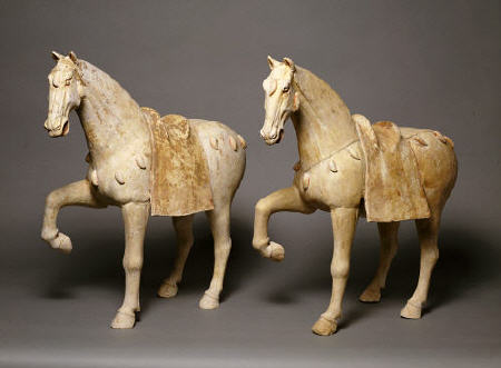 A Pair Of Buff Pottery Figures Of Prancing Caparisoned Horses od 