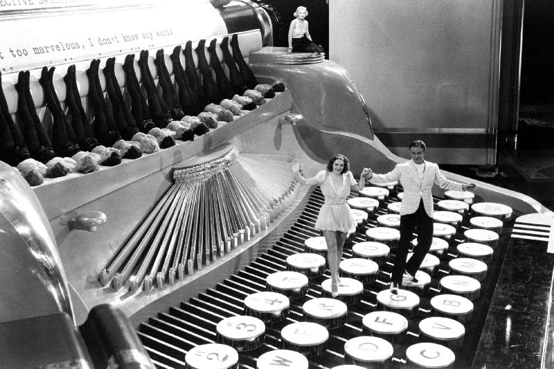 Couple dancing on the key of a giant typewriter, keys are leg of dancers, musical od 