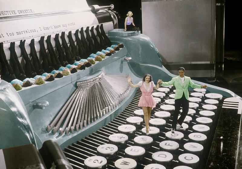 Couple dancing on the key of a giant typewriter, keys are leg of dancers, musical, 30's colourized d od 