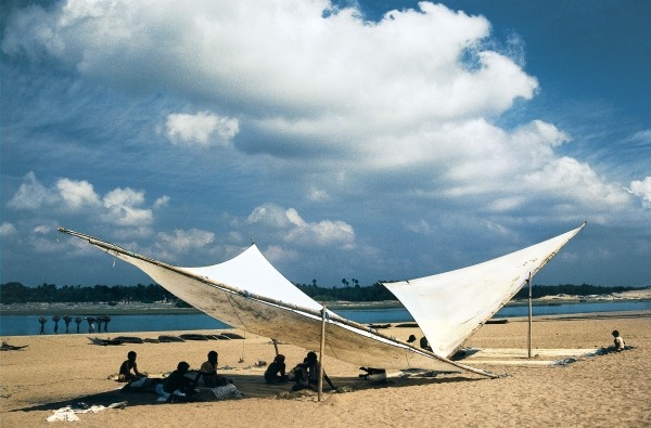 Fishermen mending their nets under shade of triangular sails, Gopalpur (photo)  od 