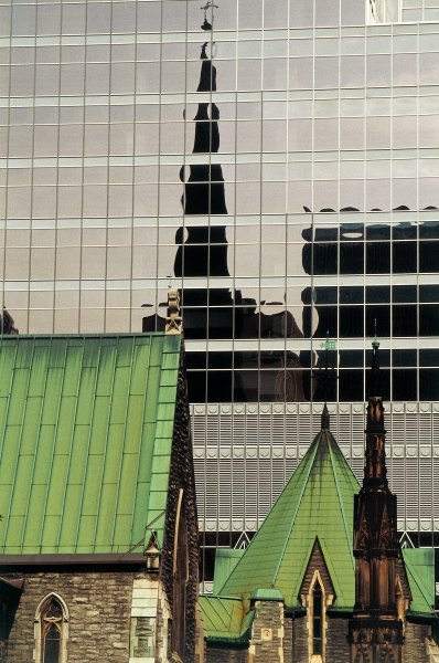 Green roofs and church reflected in glass panels (photo)  od 