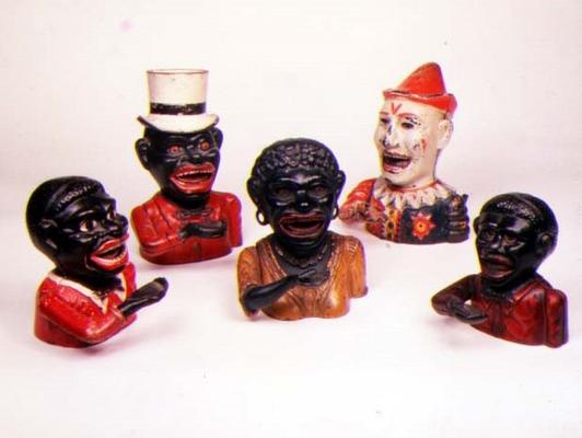 Group of Mechanical cast iron money banks. Left to right: Jolly Nigger with Butterfly Tie, Jolly Nig od 