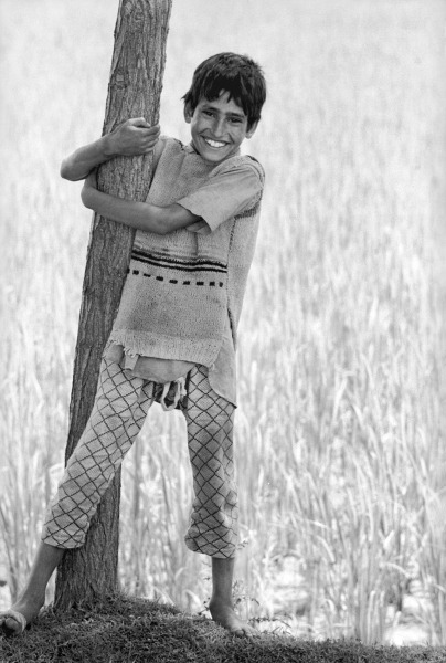 Kashmiri boy holding tree trunk (b/w photo)  od 