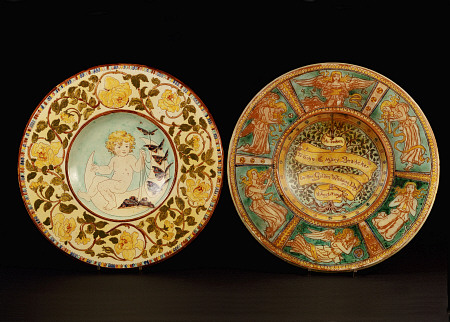 Two Della Robbia Wall Chargers, One Depicting A Putto Riding A Crescent Moon, The Other Designed By od 
