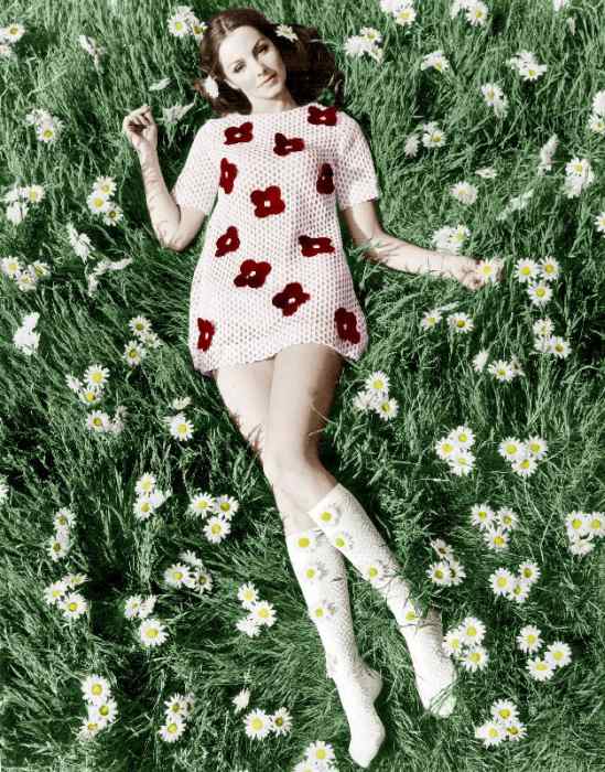 Young model Biddy Lampard in the grass wearing a short dress inspired by Courreges colourized docume od 