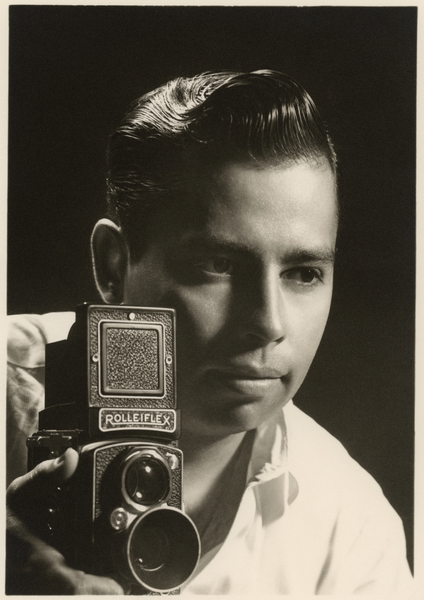 Orlando Suero portrait with Rolleiflex camera, c od Orlando Suero