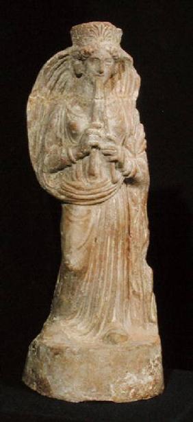 Statuette of a woman playing a double flute, from Tunisia