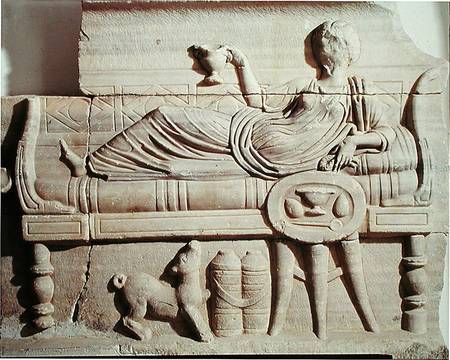 Detail from a sarcophagus depicting a woman reclining on a bench od Roman