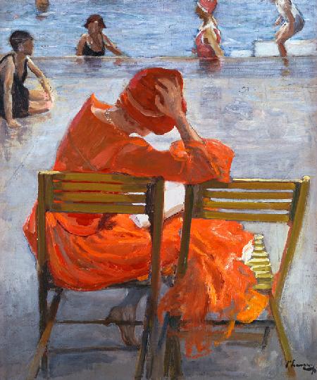 Junge Frau in einem roten Kleid an einem Swimming Pool
