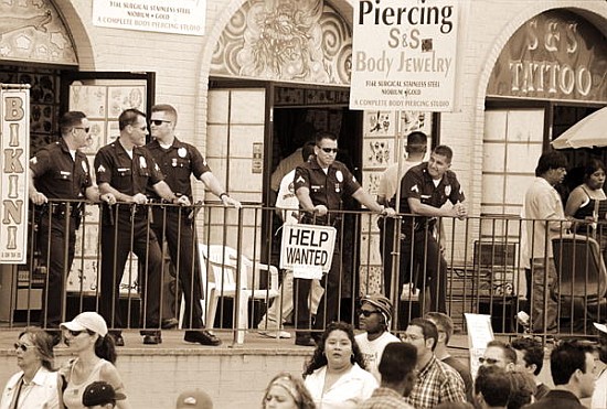 Police gathered behind a ''Help Wanted'' sign, 2004 (b/w photo)  od Stephen  Spiller