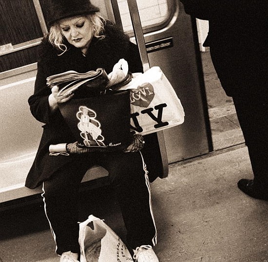 Woman reading on a subway with a Marilyn Monroe purse and an ''I Love New York'' bag, 2004 (b/w phot od Stephen  Spiller